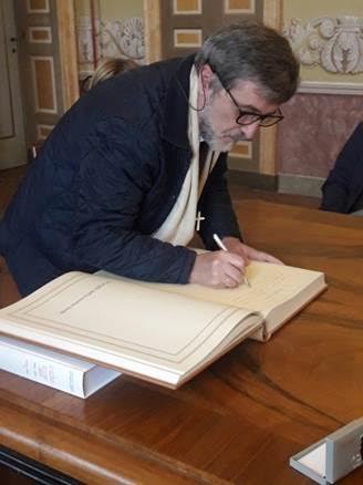padre Gianbattista moroni firma il libro d'onore della città