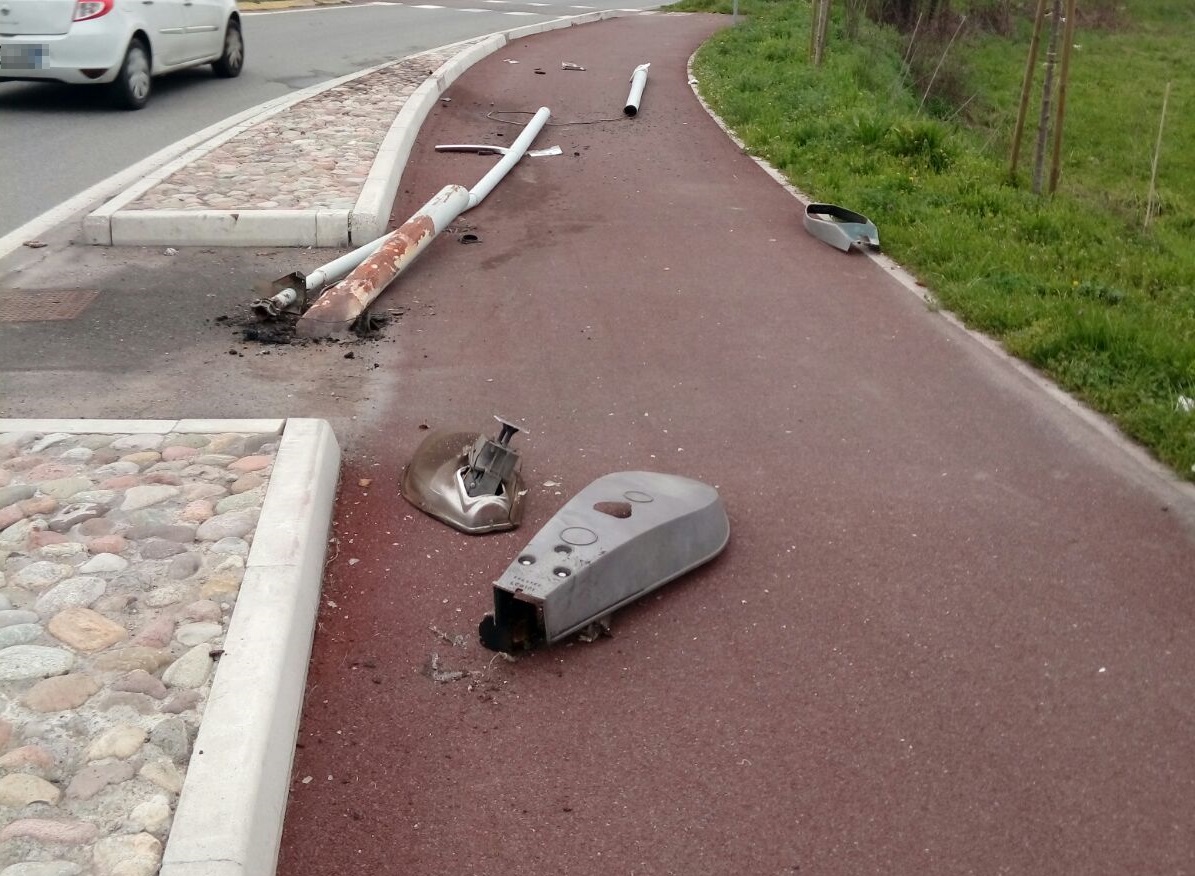 Abbatte un lampione che cade sulla pista ciclabile